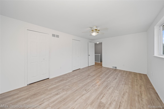 29656 Brentwood St, Southfield, MI 48076 - unfurnished bedroom featuring two closets, wood finished floors, and a ceiling fan