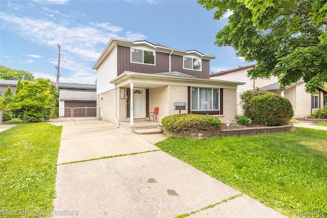 29656 Brentwood St, Southfield, MI 48076 - traditional-style house with covered porch, brick siding, board and batten siding, and a gate