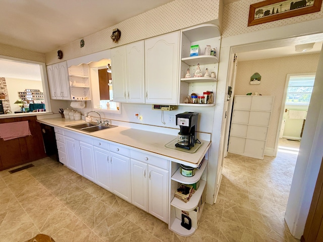 16130 Addison Rd, Addison, MI 49220 - kitchen with open shelves, wallpapered walls, white cabinets, and light countertops