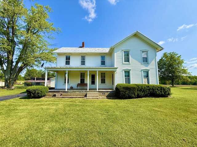 16130 Addison Rd, Addison, MI 49220 - view of front of property featuring a chimney, covered porch, and a front lawn