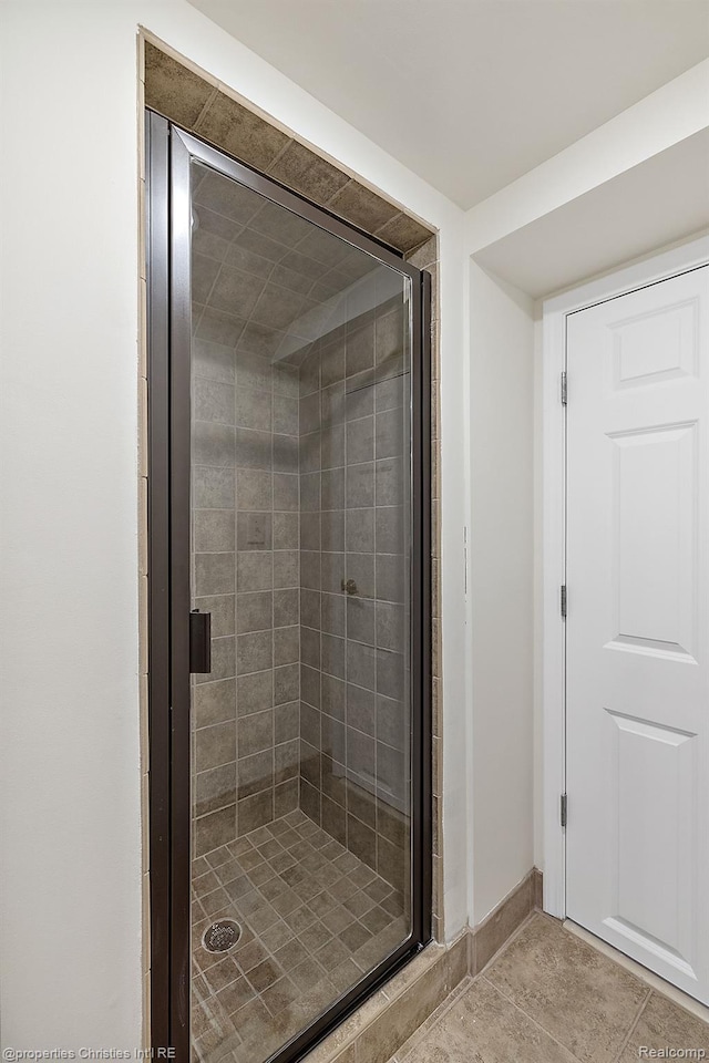 1174 Lakeside Dr, Birmingham, MI 48009 - bathroom with a stall shower and tile patterned flooring