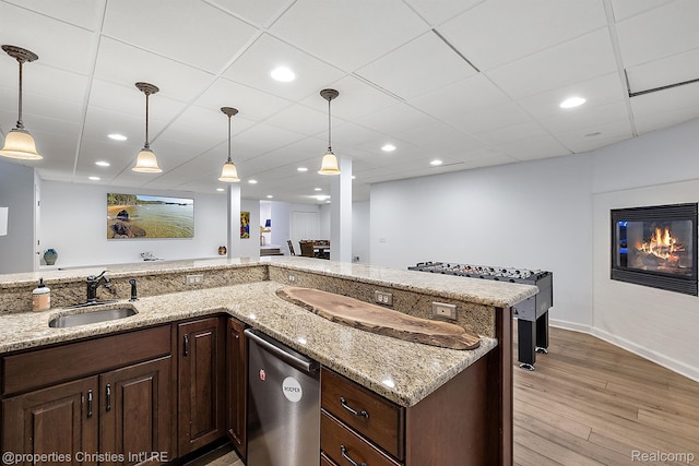 1174 Lakeside Dr, Birmingham, MI 48009 - kitchen featuring stainless steel dishwasher, light wood finished floors, dark brown cabinets, light stone counters, and recessed lighting