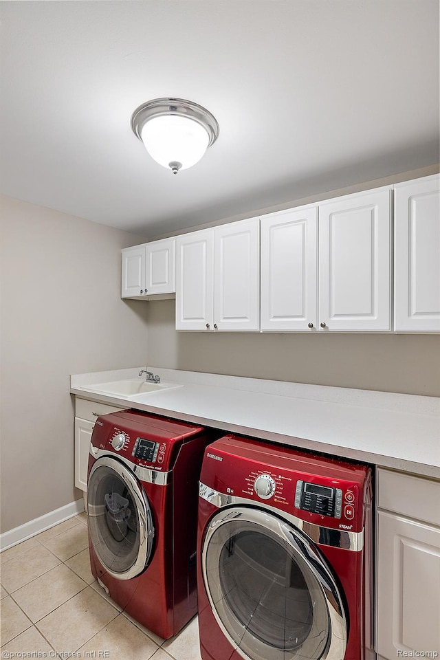 1174 Lakeside Dr, Birmingham, MI 48009 - laundry room featuring washer and clothes dryer, cabinet space, and light tile patterned floors