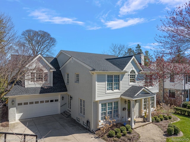 1174 Lakeside Dr, Birmingham, MI 48009 - view of front of home with driveway, brick siding, a shingled roof, entry steps, and a chimney