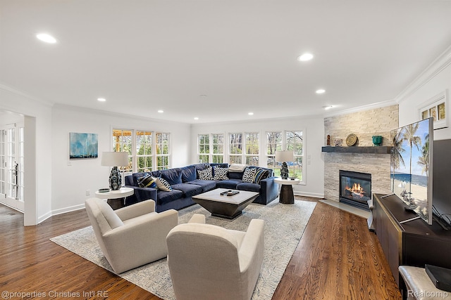 1174 Lakeside Dr, Birmingham, MI 48009 - living room featuring ornamental molding, a stone fireplace, plenty of natural light, dark wood-style flooring, and recessed lighting