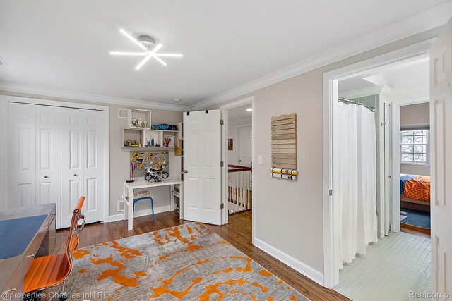 1174 Lakeside Dr, Birmingham, MI 48009 - bedroom with wood finished floors, crown molding, and a closet