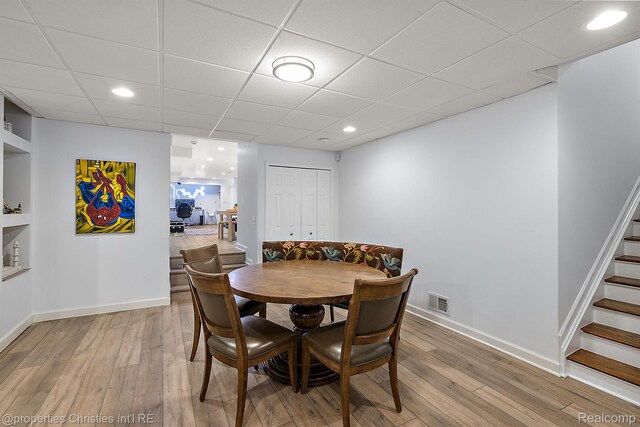 1174 Lakeside Dr, Birmingham, MI 48009 - dining room featuring light wood-style flooring, stairs, a drop ceiling, and recessed lighting