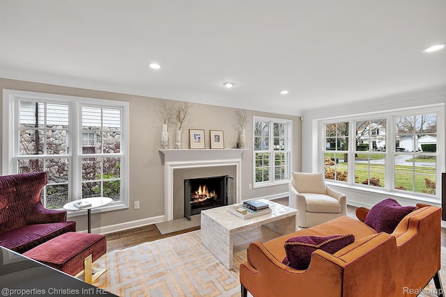 1174 Lakeside Dr, Birmingham, MI 48009 - living room featuring plenty of natural light, recessed lighting, a fireplace with flush hearth, and wood finished floors