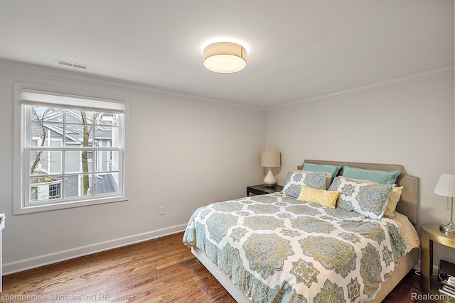 1174 Lakeside Dr, Birmingham, MI 48009 - bedroom with wood finished floors and crown molding