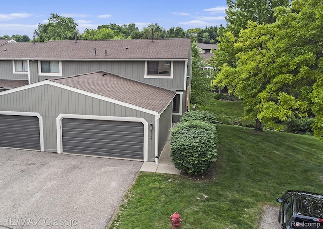 854 Yorktown Ct, Northville, MI 48167 - view of front of home with a shingled roof, a front yard, asphalt driveway, and an attached garage