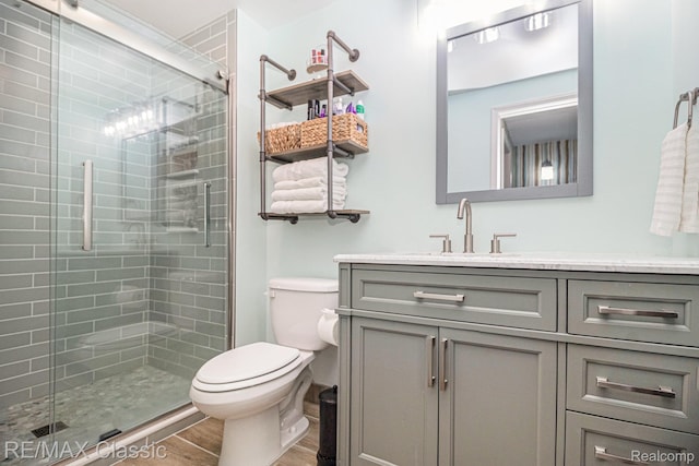 854 Yorktown Ct, Northville, MI 48167 - bathroom with vanity, a shower stall, and wood finished floors