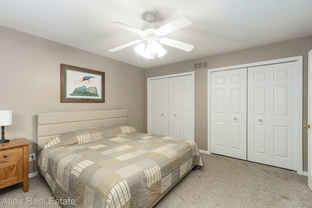 3527 Applewood Ln Unit 2, Grand Blanc, MI 48439 - bedroom featuring two closets, light carpet, and ceiling fan