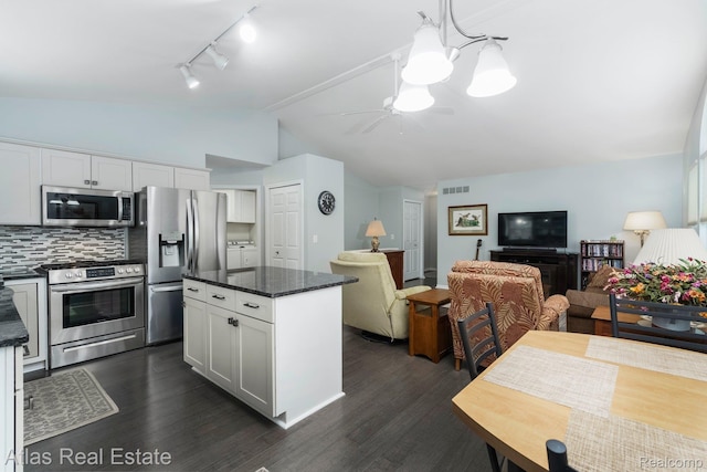 3527 Applewood Ln Unit 2, Grand Blanc, MI 48439 - kitchen featuring stainless steel appliances, open floor plan, vaulted ceiling, rail lighting, and a chandelier