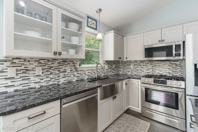 3527 Applewood Ln Unit 2, Grand Blanc, MI 48439 - kitchen with stainless steel appliances, lofted ceiling, decorative backsplash, glass insert cabinets, and dark stone counters