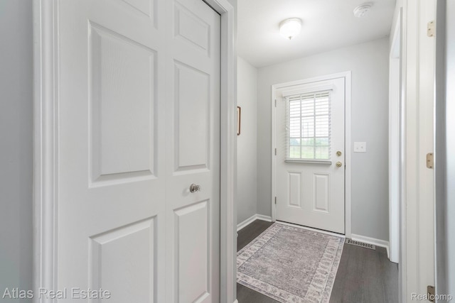 3527 Applewood Ln Unit 2, Grand Blanc, MI 48439 - doorway to outside with dark wood-style floors and baseboards