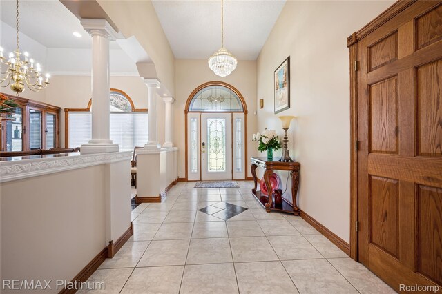 8922 Mcclements Rd, Brighton, MI 48114 - foyer entrance with a chandelier, plenty of natural light, ornate columns, and a high ceiling