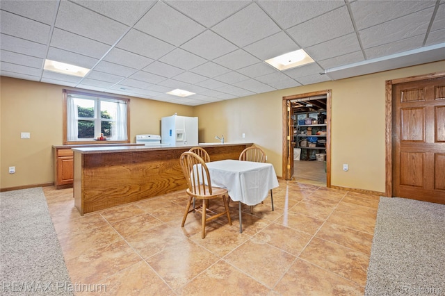 8922 Mcclements Rd, Brighton, MI 48114 - dining area featuring a paneled ceiling and washer / dryer