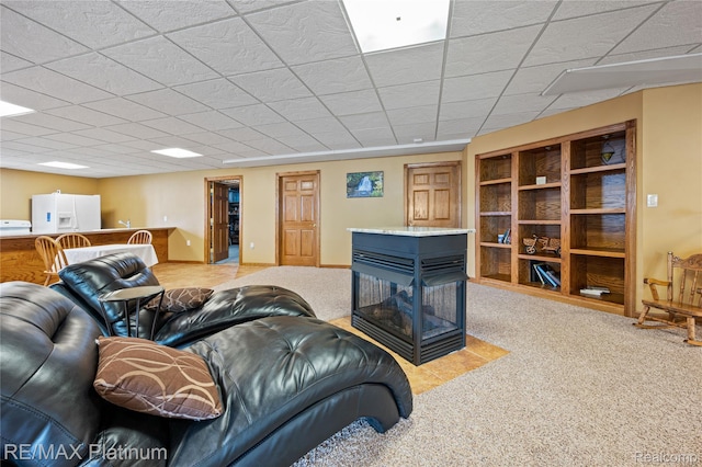 8922 Mcclements Rd, Brighton, MI 48114 - living area with a multi sided fireplace, carpet flooring, and a paneled ceiling