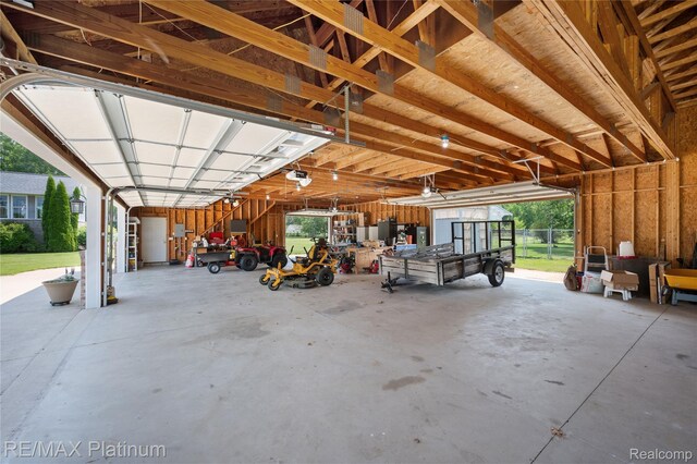 8922 Mcclements Rd, Brighton, MI 48114 - garage featuring a garage door opener