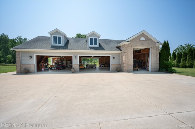 8922 Mcclements Rd, Brighton, MI 48114 - view of front facade with brick siding, driveway, roof with shingles, and a garage