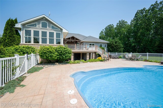 8922 Mcclements Rd, Brighton, MI 48114 - view of pool with stairway, a fenced backyard, a patio area, and a wooden deck