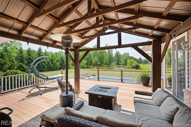 8922 Mcclements Rd, Brighton, MI 48114 - wooden terrace with an outdoor living space with a fire pit, a gazebo, and a water view