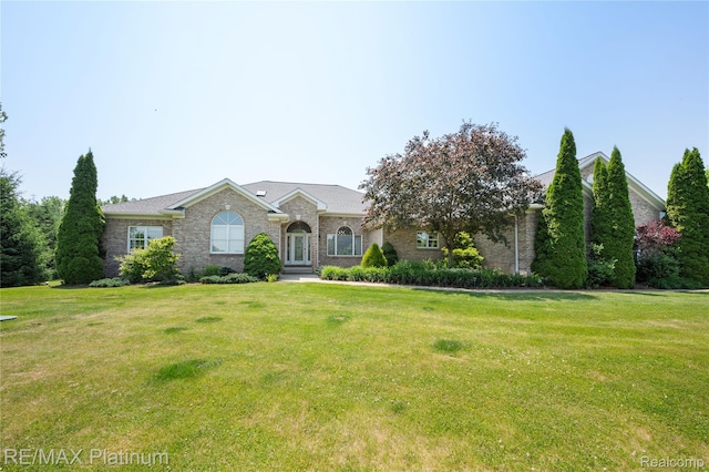 8922 Mcclements Rd, Brighton, MI 48114 - view of front of property with a front yard and brick siding