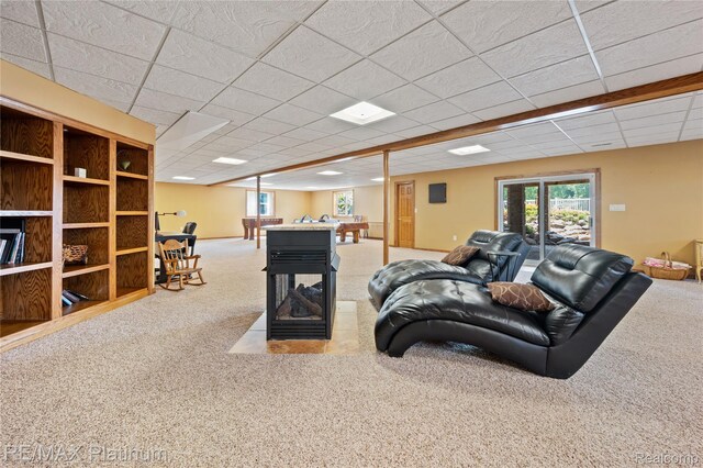 8922 Mcclements Rd, Brighton, MI 48114 - living area with carpet floors, plenty of natural light, and a paneled ceiling