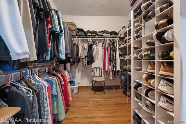 8922 Mcclements Rd, Brighton, MI 48114 - walk in closet featuring wood finished floors