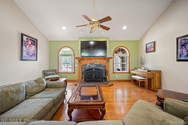 8922 Mcclements Rd, Brighton, MI 48114 - living room featuring ceiling fan, wood finished floors, a premium fireplace, recessed lighting, and high vaulted ceiling