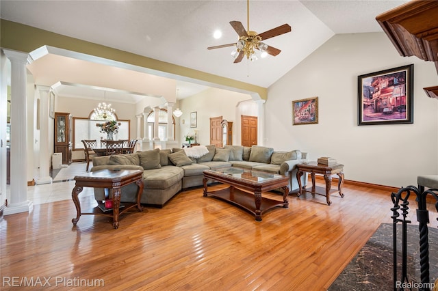8922 Mcclements Rd, Brighton, MI 48114 - living room featuring decorative columns, ceiling fan, light wood finished floors, lofted ceiling, and a chandelier