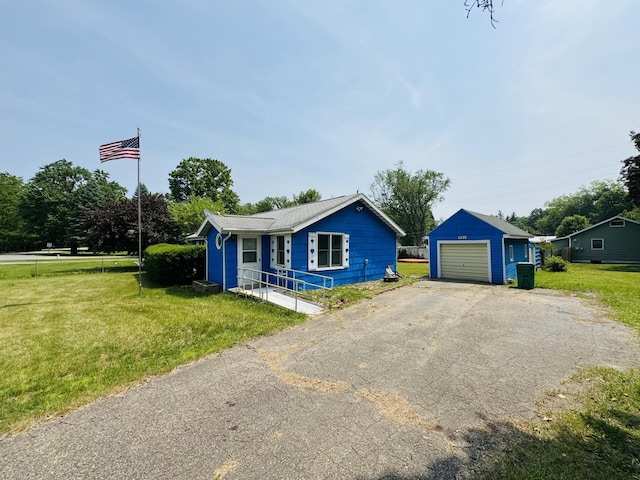 1225 Huntly Rd, Niles, MI 49120 - view of front of house featuring an outbuilding, a front yard, a garage, and asphalt driveway