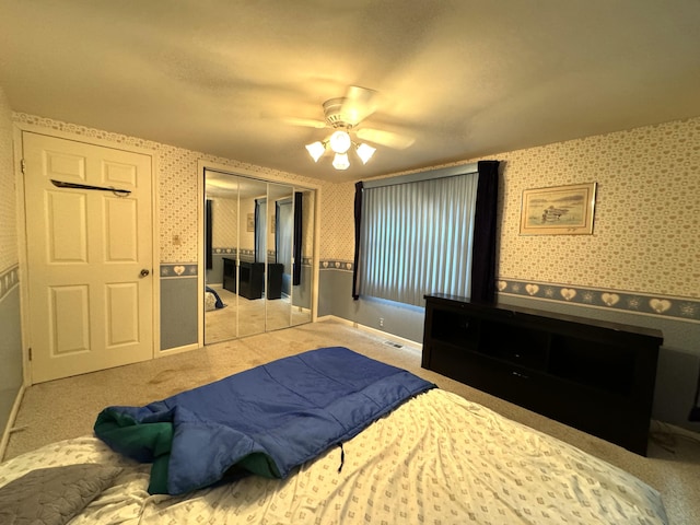 1225 Huntly Rd, Niles, MI 49120 - carpeted bedroom with wallpapered walls, a closet, and a ceiling fan