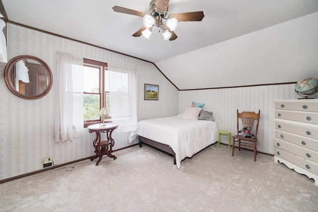 3750 River Rd, Manistee, MI 49660 - carpeted bedroom with wallpapered walls, vaulted ceiling, and ceiling fan