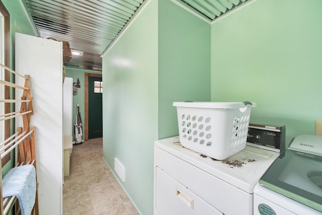 3750 River Rd, Manistee, MI 49660 - laundry room with washing machine and dryer and light tile patterned floors
