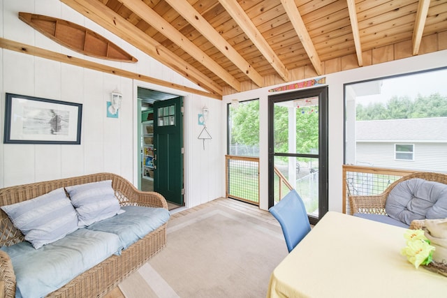 3750 River Rd, Manistee, MI 49660 - living area featuring wooden ceiling, healthy amount of natural light, light colored carpet, and wooden walls