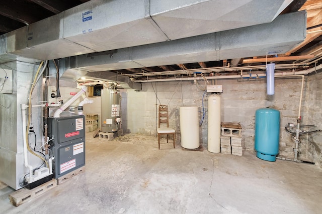 3750 River Rd, Manistee, MI 49660 - unfinished below grade area featuring gas water heater, a water pressure tank, a water softener, and heating unit