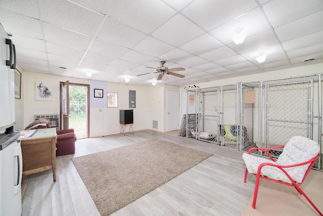 3750 River Rd, Manistee, MI 49660 - living room with a drop ceiling, ceiling fan, light wood-type flooring, and electric panel