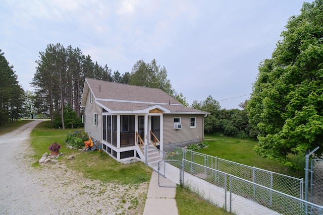 3750 River Rd, Manistee, MI 49660 - bungalow-style house featuring a gate, roof with shingles, and a sunroom