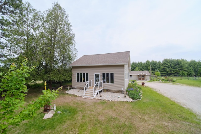 3750 River Rd, Manistee, MI 49660 - back of property featuring a lawn