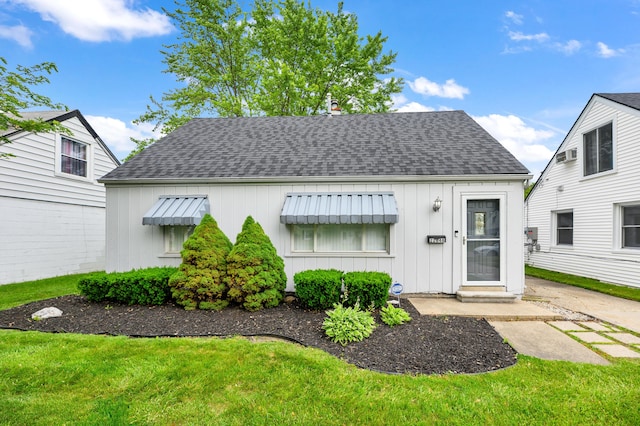 22848 Almond Ave, Eastpointe, MI 48021 - bungalow-style home featuring a shingled roof, board and batten siding, and a front yard