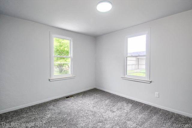 1372 S Packard Ave, Burton, MI 48509 - carpeted spare room featuring baseboards