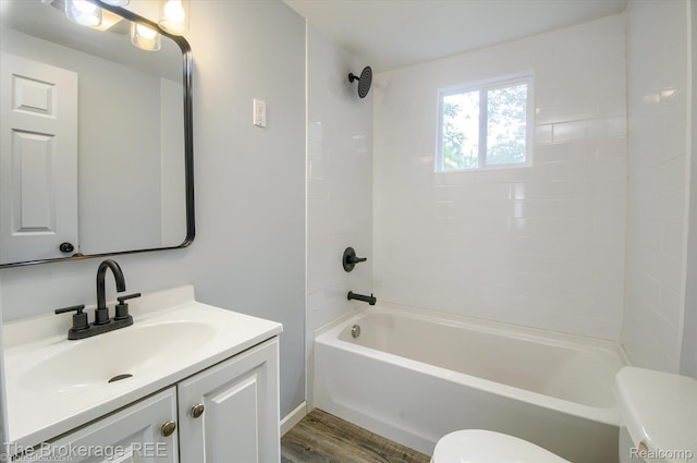 1372 S Packard Ave, Burton, MI 48509 - full bathroom featuring wood finished floors, vanity, and bathtub / shower combination