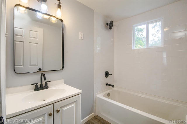 1372 S Packard Ave, Burton, MI 48509 - bathroom featuring vanity,  shower combination, and wood finished floors