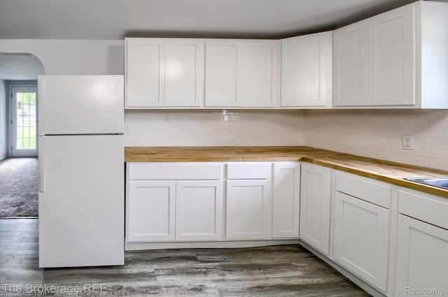 1372 S Packard Ave, Burton, MI 48509 - kitchen with freestanding refrigerator, butcher block counters, white cabinetry, and arched walkways