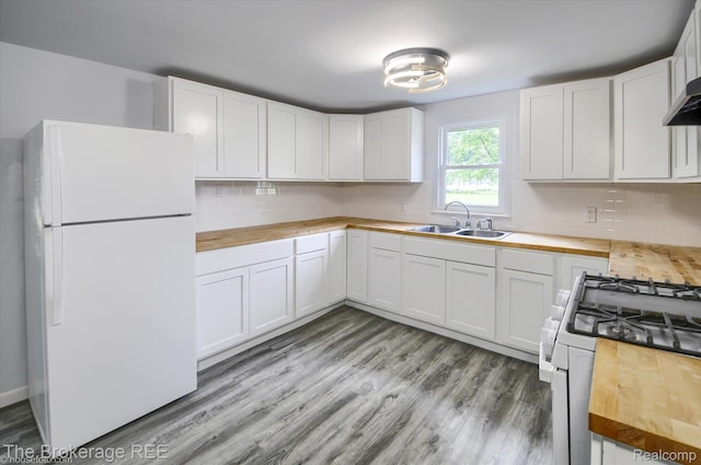 1372 S Packard Ave, Burton, MI 48509 - kitchen with white appliances, wooden counters, tasteful backsplash, and light wood-type flooring