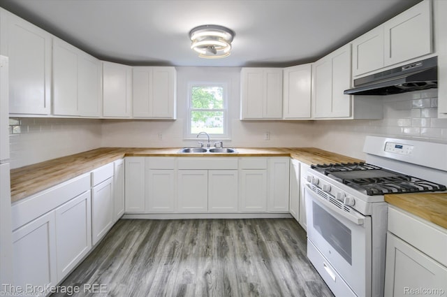 1372 S Packard Ave, Burton, MI 48509 - kitchen with gas range gas stove, under cabinet range hood, butcher block counters, white cabinetry, and decorative backsplash