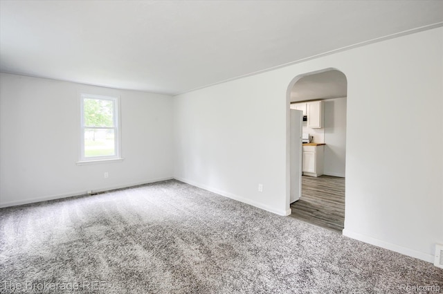1372 S Packard Ave, Burton, MI 48509 - unfurnished room featuring carpet flooring and arched walkways