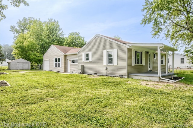 1372 S Packard Ave, Burton, MI 48509 - rear view of house with crawl space, a shed, and covered porch