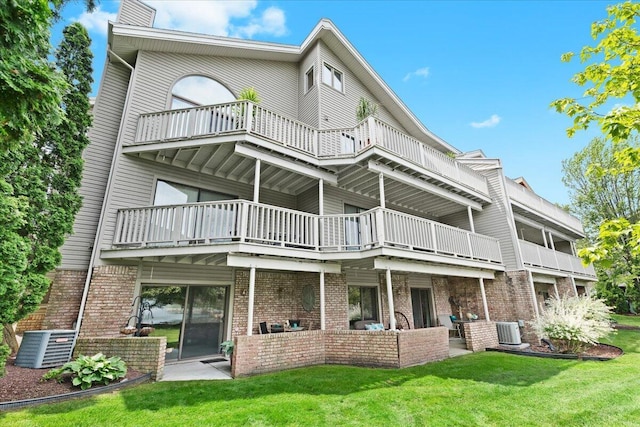 21112 Boulder Cir, Northville, MI 48167 - rear view of property featuring a balcony, brick siding, a lawn, an outdoor hangout area, and a patio area